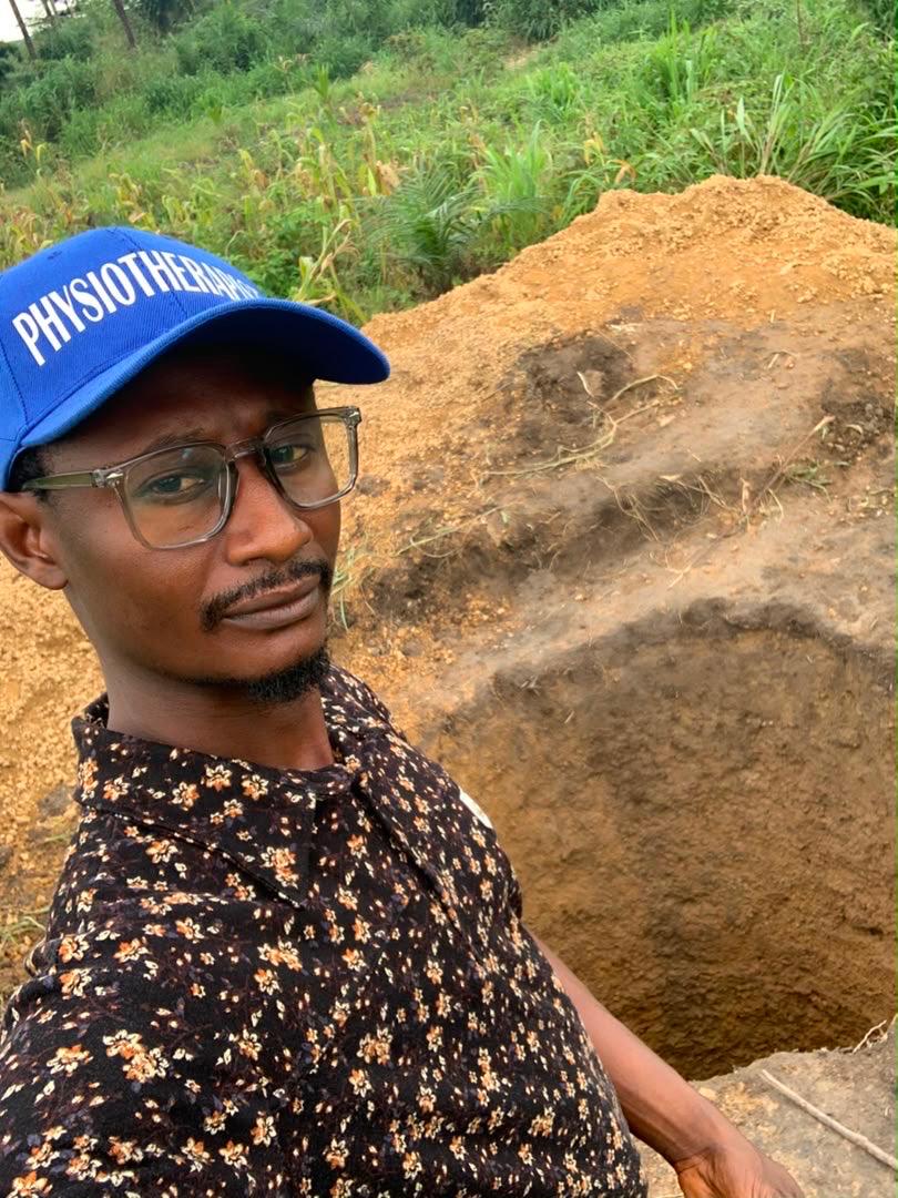 John, in his physiotherapist cap, standing at the excavated Clinic One site